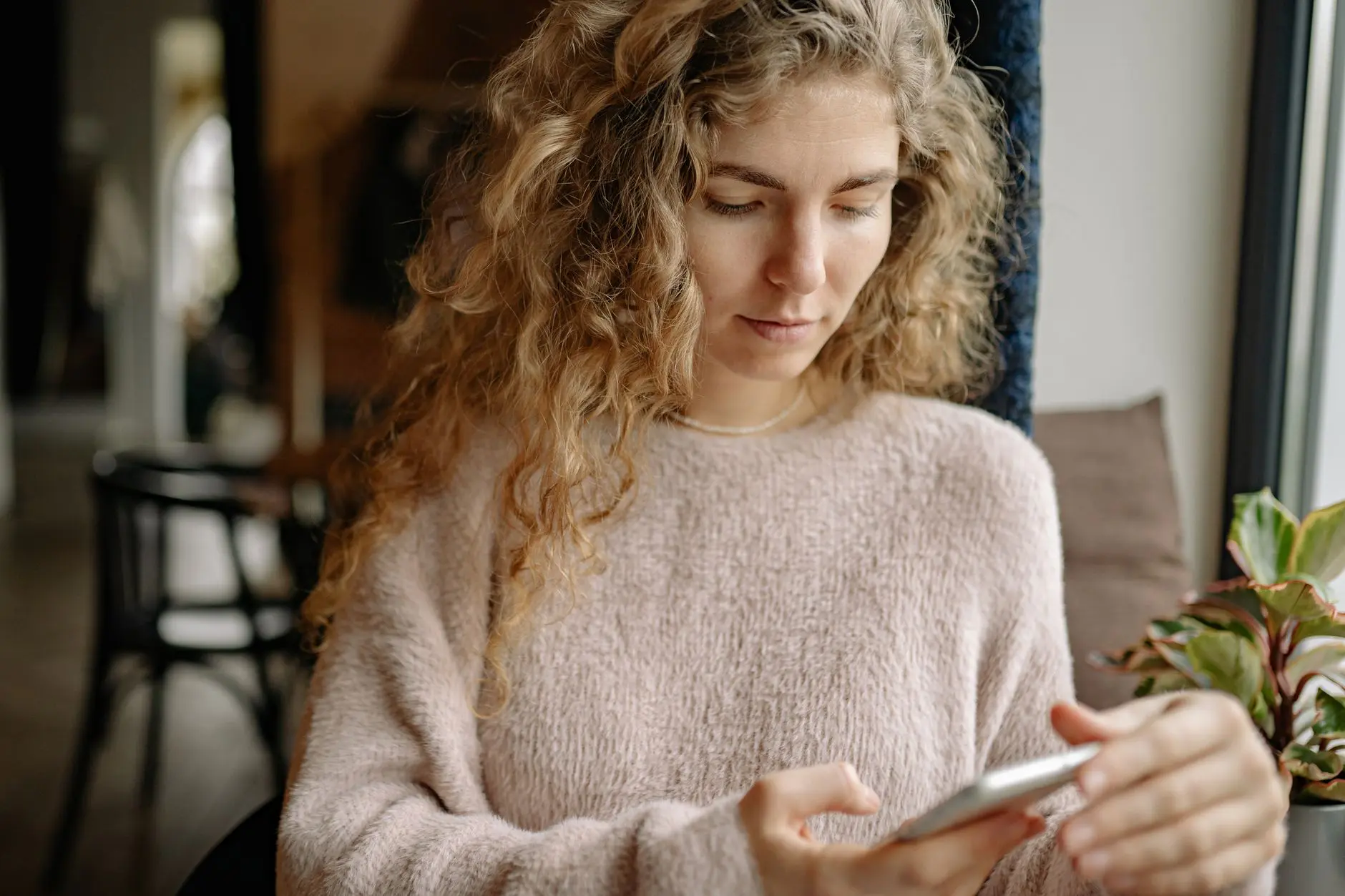 A woman answering a few questions on her phone to start her plan