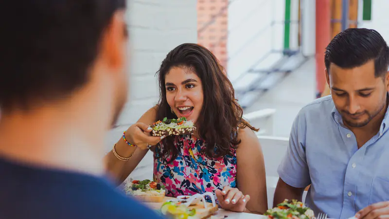 Friends sharing a meal at a restaurant table