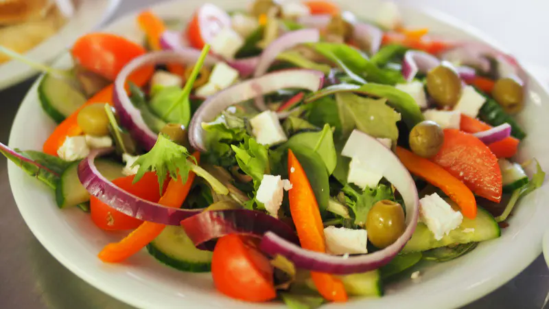 Mediterranean salad with tomatoes, cucumber, red onion, olives and feta