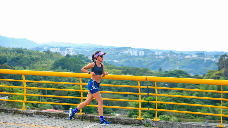 A woman running outdoors on a sunny day